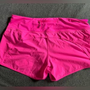 Neon pink Lululemon running shorts. No tag for size. Assuming to fit a medium.